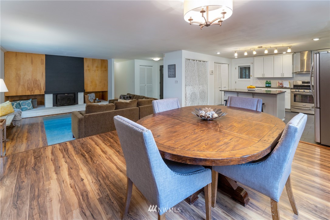 16945 Southeast 149th Street Renton, WA 98059 - Photo 9 of 40 a large kitchen with kitchen island a dining table and chairs