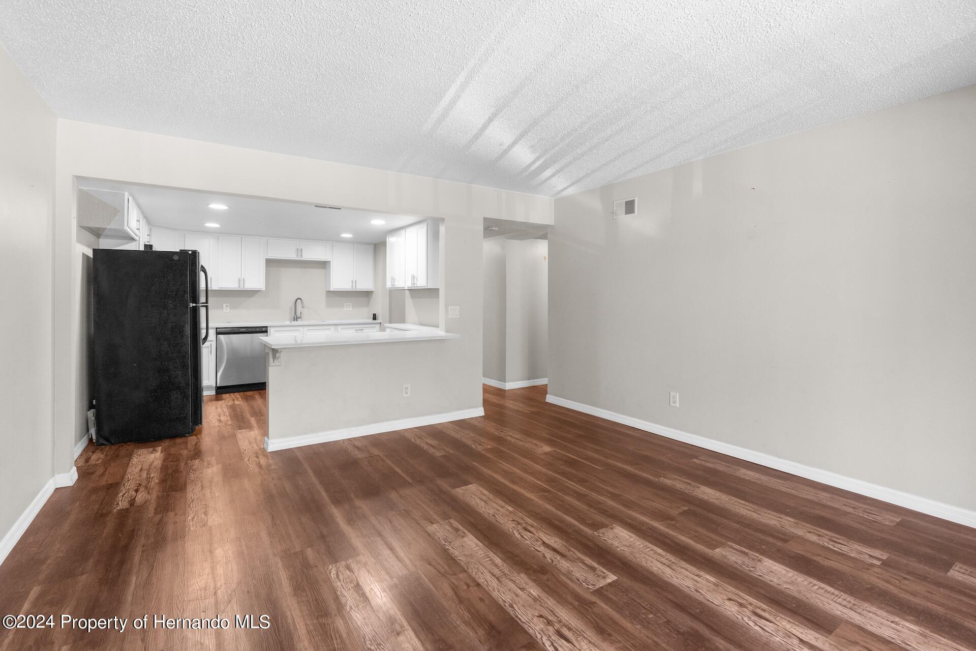 5541 Bay Boulevard Port Richey, FL 34668 - Photo 12 of 22 a view of kitchen with wooden floor