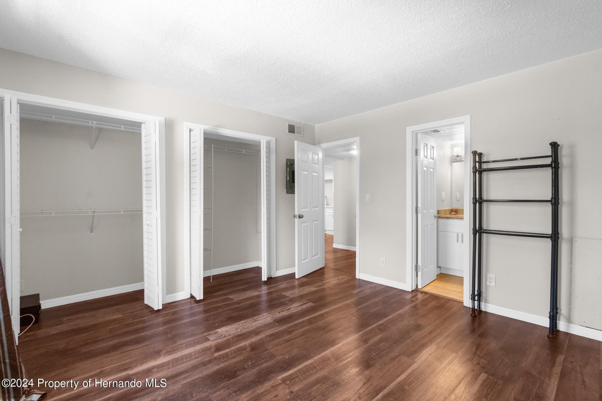 5541 Bay Boulevard Port Richey, FL 34668 - Photo 14 of 22 a view of an empty room with wooden floor