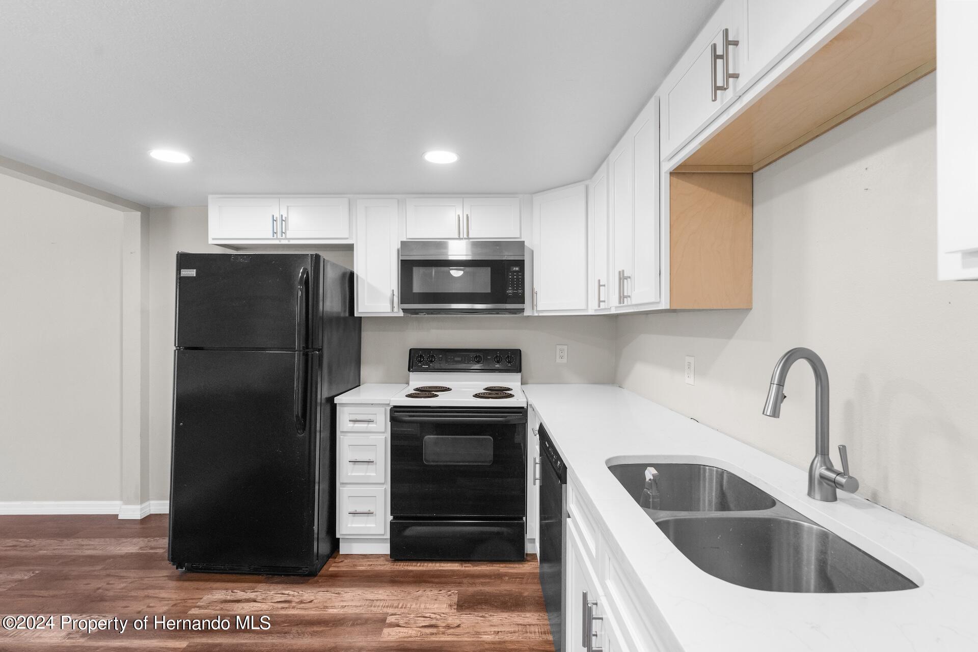 5541 Bay Boulevard Port Richey, FL 34668 - Photo 5 of 22 a kitchen with a refrigerator sink and stove