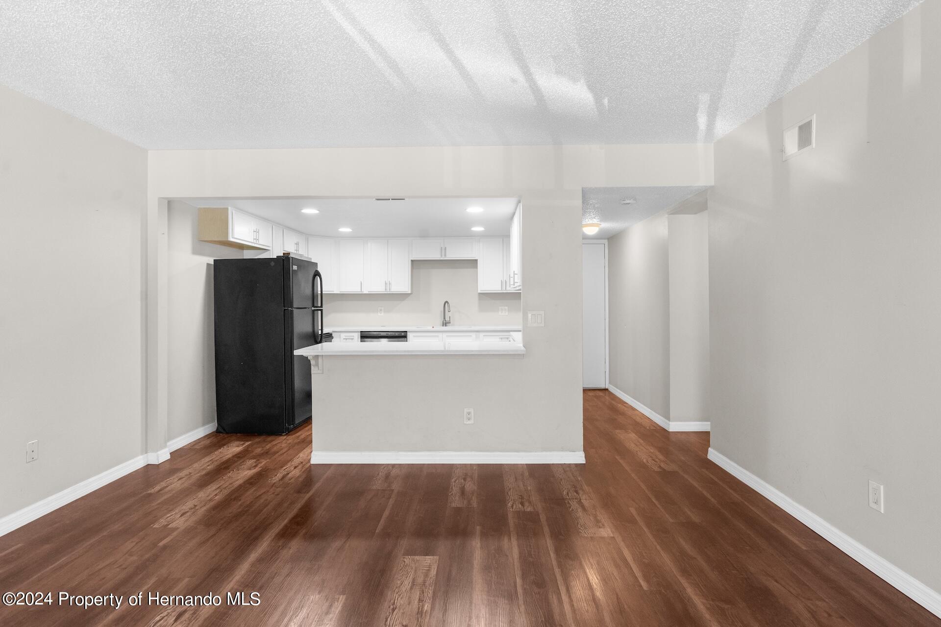 5541 Bay Boulevard Port Richey, FL 34668 - Photo 9 of 22 a view of kitchen with wooden floor