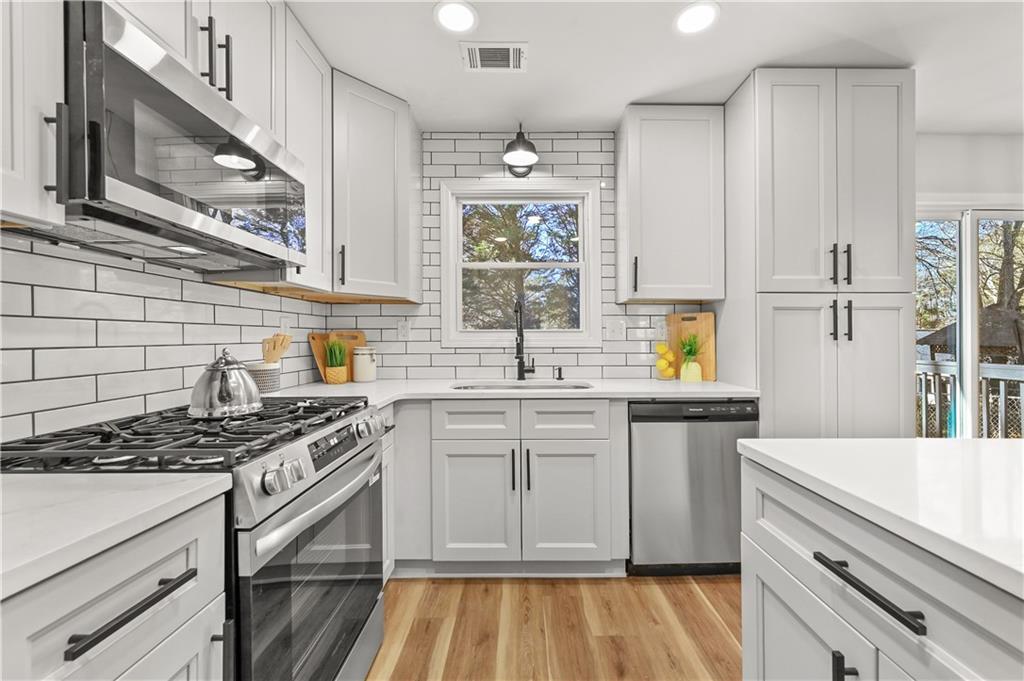 3413 Underwood Road Southeast Conyers, GA 30013 - Photo 15 of 42 a kitchen with stainless steel appliances granite countertop a sink stove and cabinets