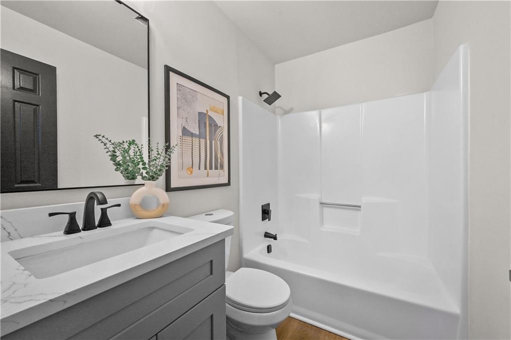 3413 Underwood Road Southeast Conyers, GA 30013 - Photo 19 of 42 a bathroom with a sink a toilet and shower