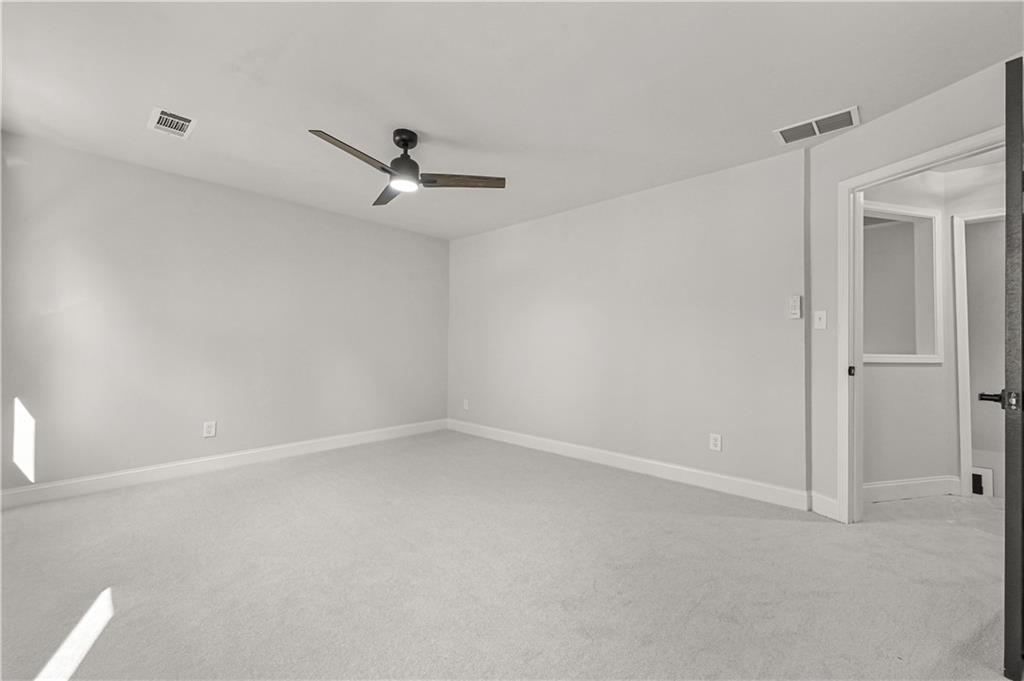 3413 Underwood Road Southeast Conyers, GA 30013 - Photo 29 of 42 an empty room with a ceiling fan and window