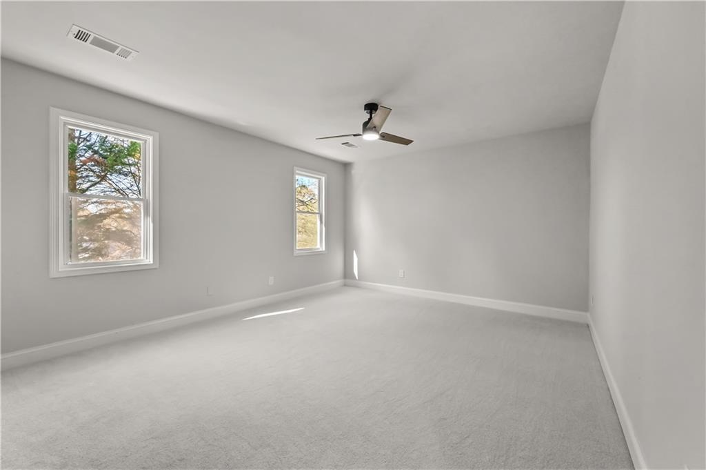 3413 Underwood Road Southeast Conyers, GA 30013 - Photo 30 of 42 an empty room with windows and fan