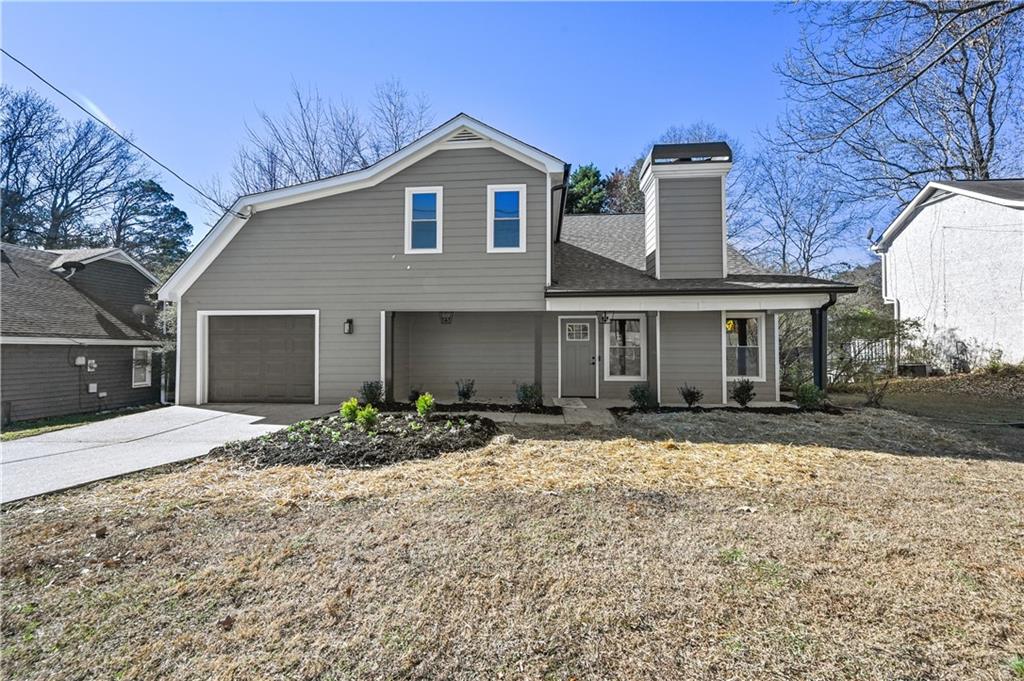 3413 Underwood Road Southeast Conyers, GA 30013 - Photo 4 of 42 a front view of a house with a yard and garage