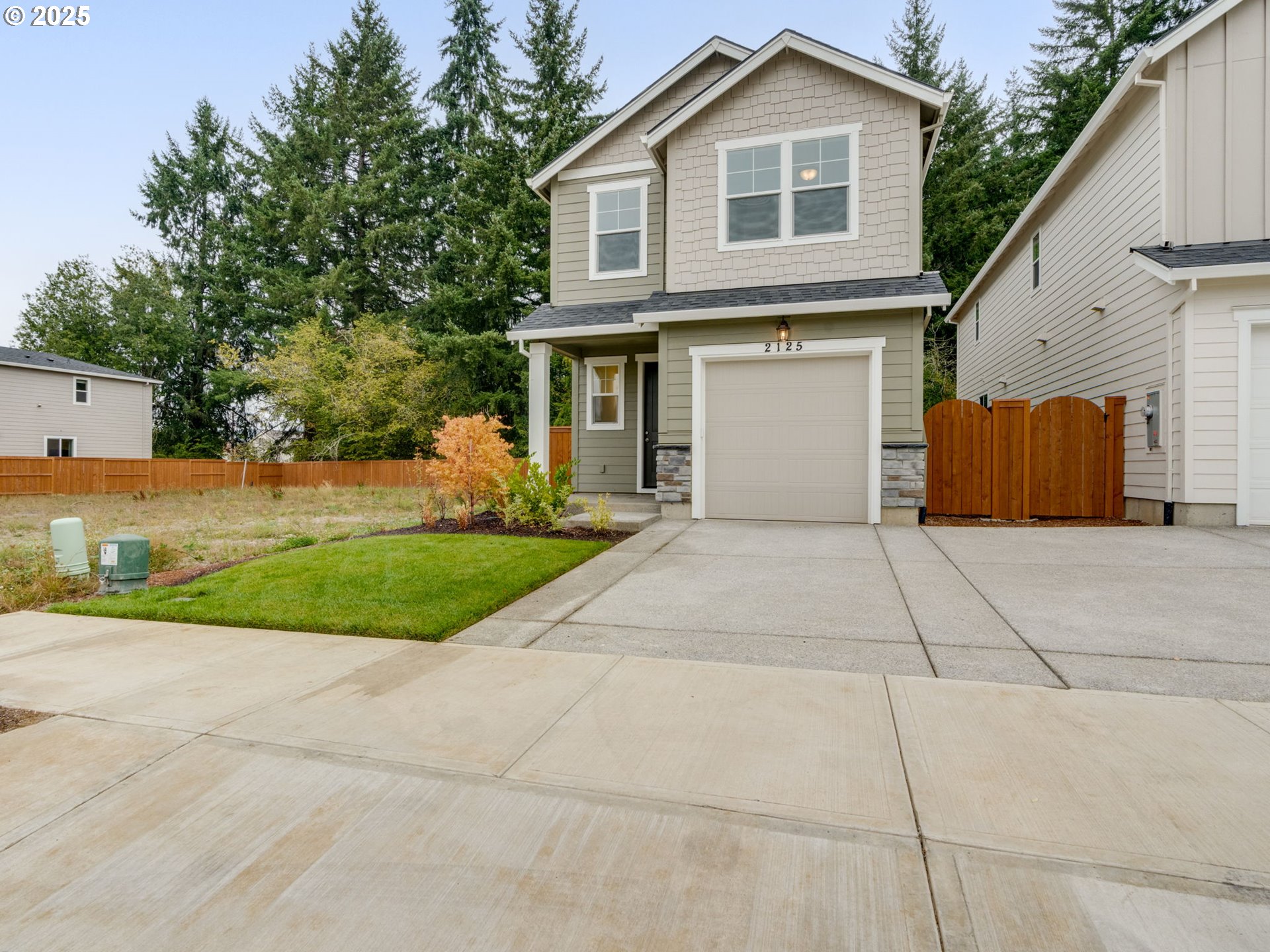 2125 Southwest 5th Place Battle Ground, WA 98604 - Photo 1 of 36 a front view of a house with a yard and potted plants