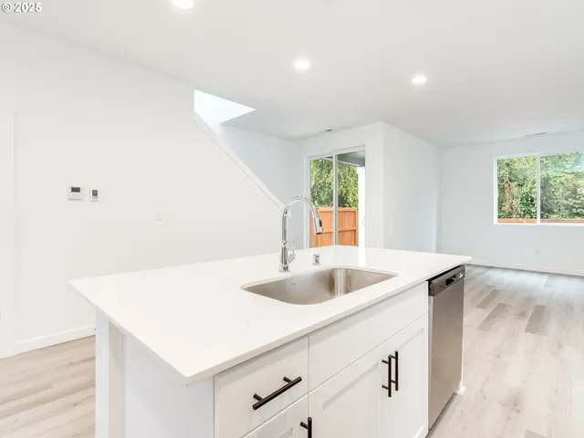 a kitchen with a sink a counter and a refrigerator