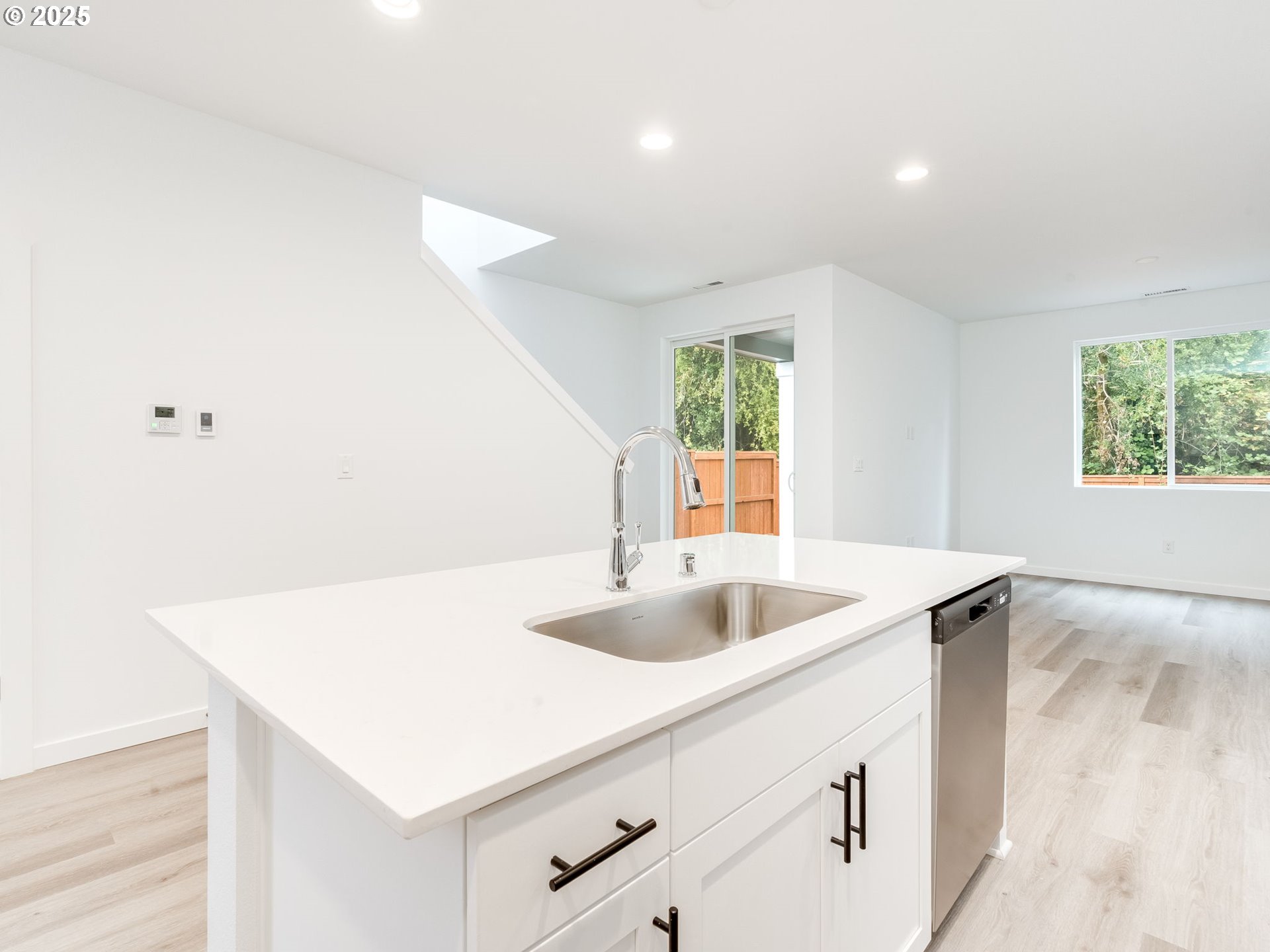 2125 Southwest 5th Place Battle Ground, WA 98604 - Photo 11 of 36 a kitchen with a sink a counter and a refrigerator