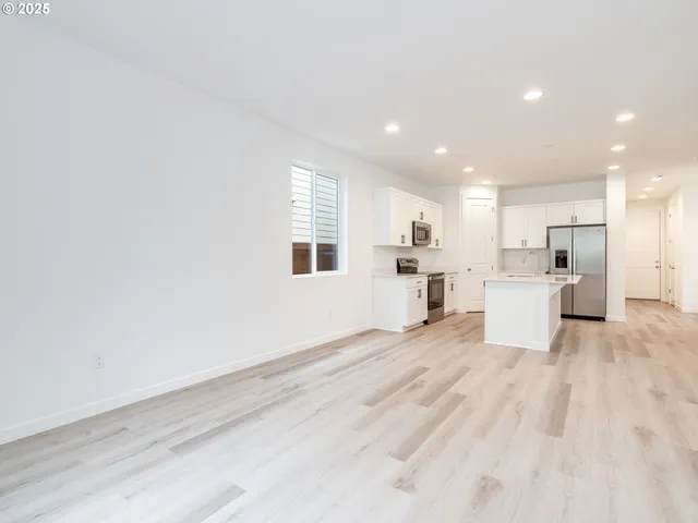 a view of a kitchen with a sink and wooden floor