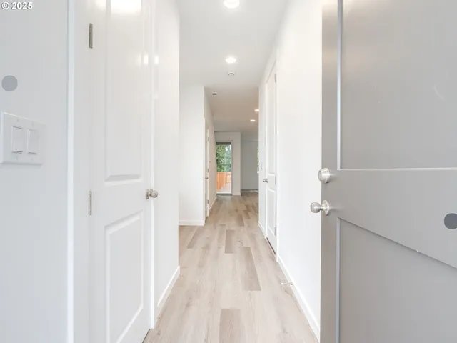 a view of a hallway with wooden floor