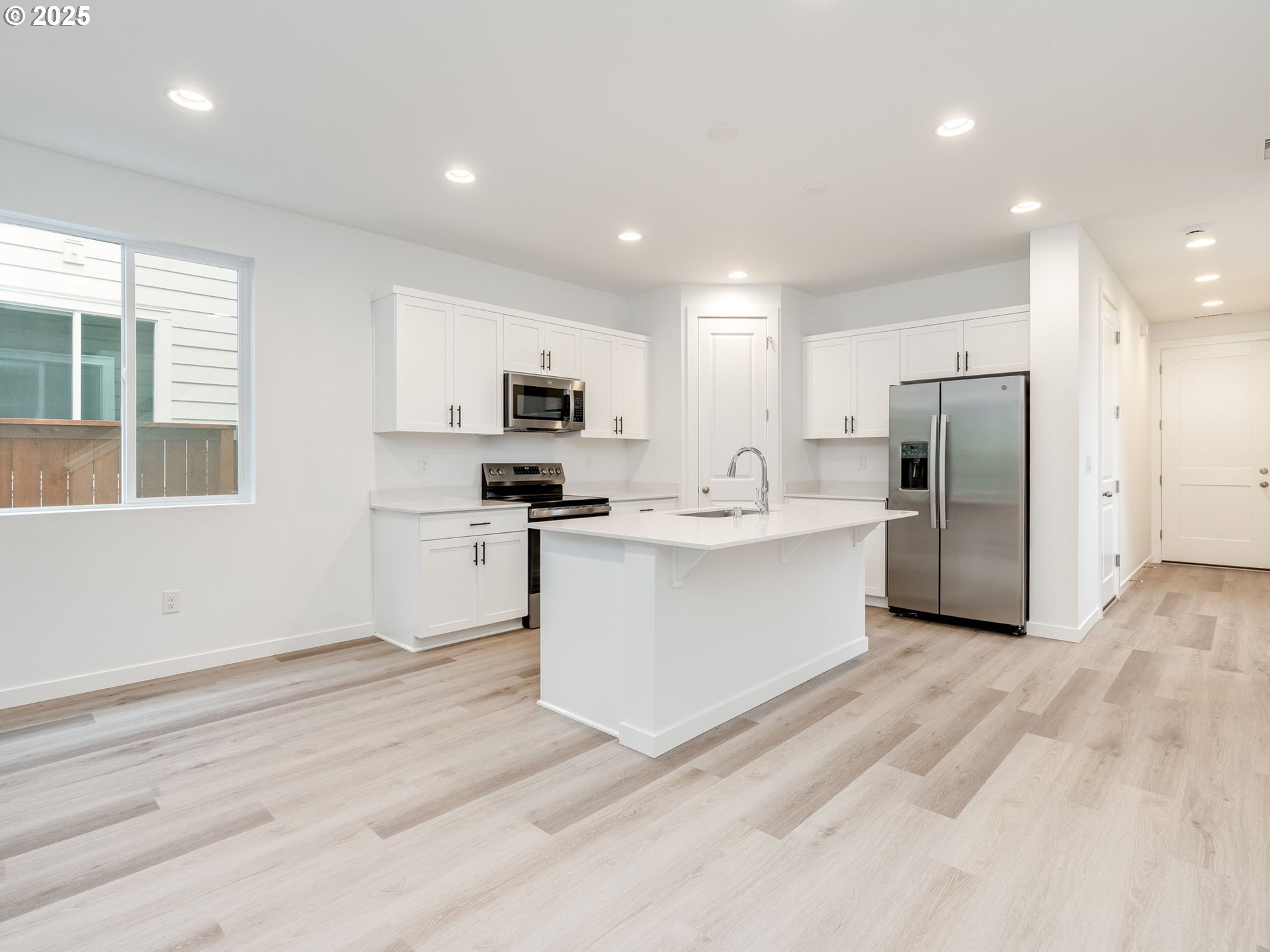 2125 Southwest 5th Place Battle Ground, WA 98604 - Photo 10 of 36 a kitchen with stainless steel appliances a refrigerator sink and microwave
