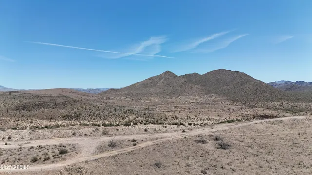 a view of a large mountain with a mountain in the background