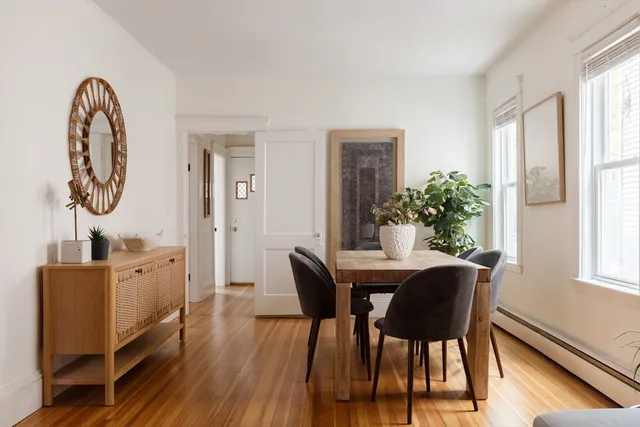a view of a dining room with furniture and wooden floor