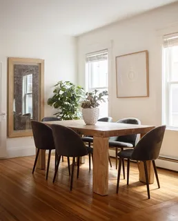 a dining room with furniture and wooden floor