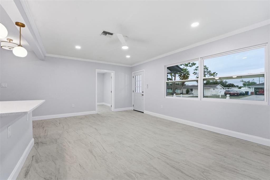 808 Guild Drive Venice, FL 34285 - Photo 13 of 27 an empty room with wooden floor and windows