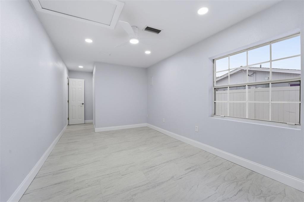 808 Guild Drive Venice, FL 34285 - Photo 15 of 27 an empty room with cabinet and windows