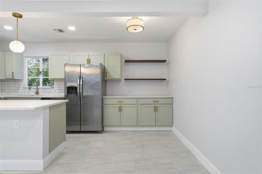 808 Guild Drive Venice, FL 34285 - Photo 6 of 27 a kitchen with a refrigerator and a sink
