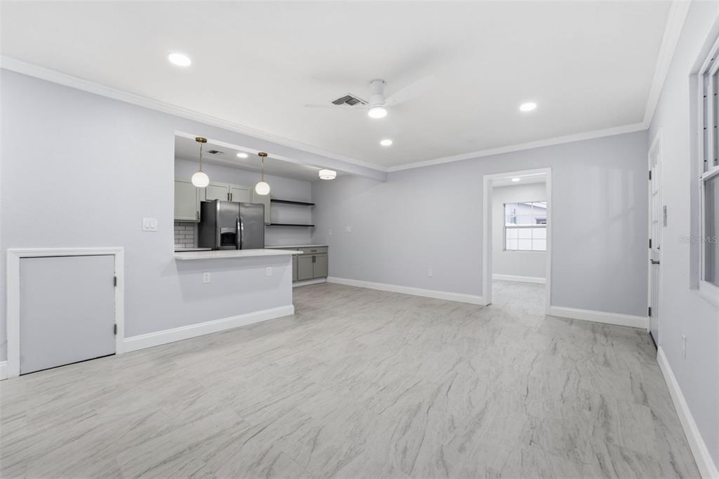 808 Guild Drive Venice, FL 34285 - Photo 8 of 27 a view of an empty room and a kitchen