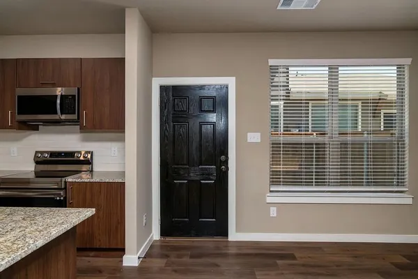 a kitchen with kitchen island granite countertop a sink stainless steel appliances and cabinets