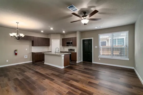 a kitchen with granite countertop a stove and a microwave