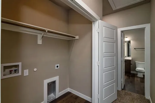 a view of a kitchen with wooden floor and a ceiling fan