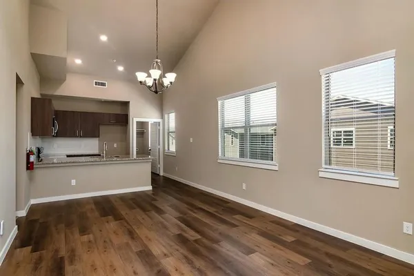 an empty room with closet and mirror