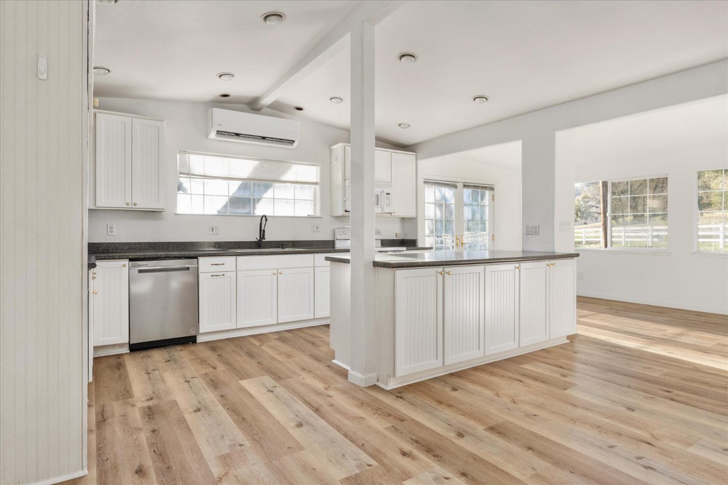8653 Hidden Valley Road Mountain Ranch, CA 95246 - Photo 12 of 41 a kitchen with stainless steel appliances granite countertop a white cabinets and wooden floor