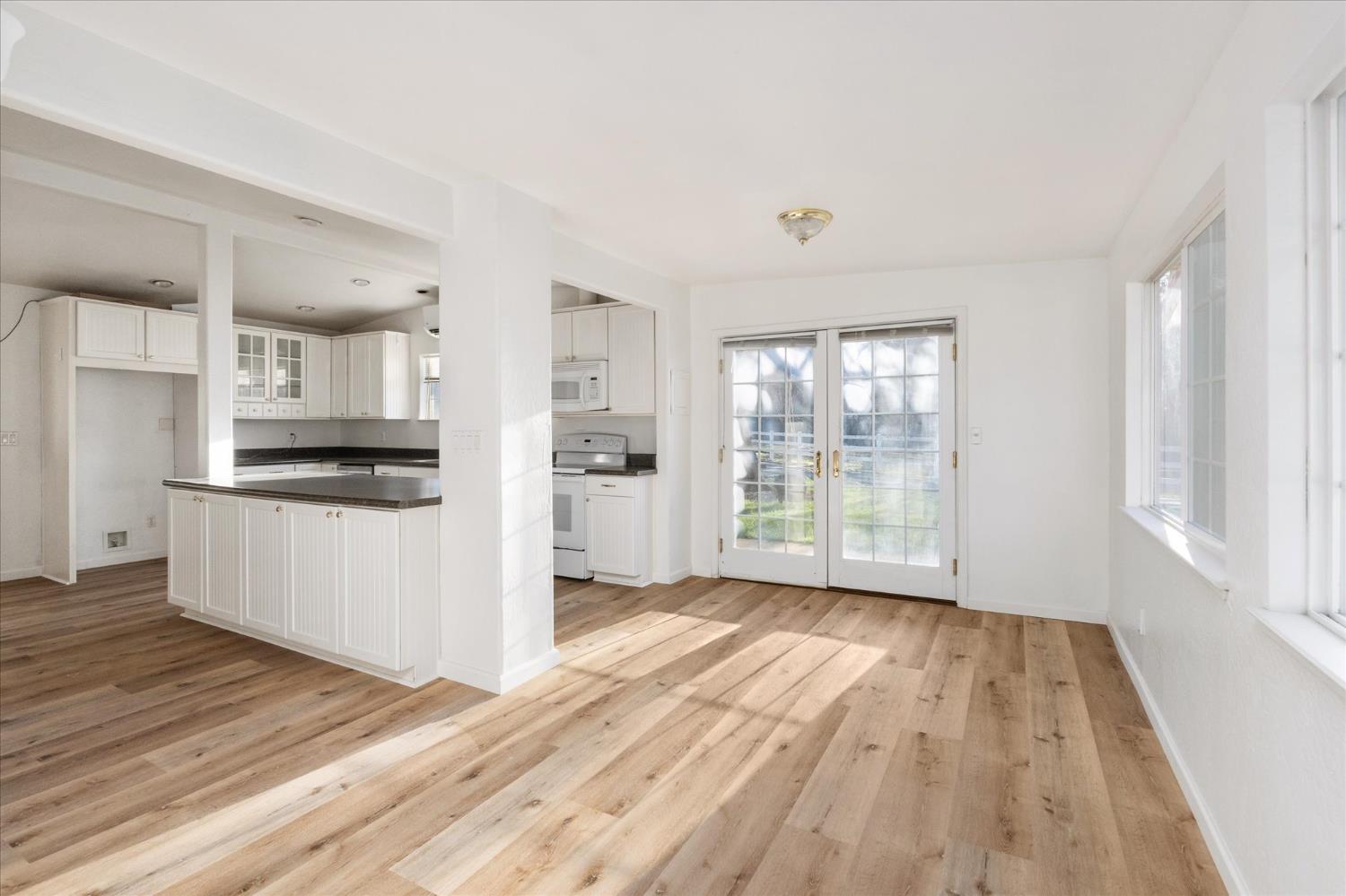 8653 Hidden Valley Road Mountain Ranch, CA 95246 - Photo 19 of 41 a view of a kitchen with wooden floor and a kitchen