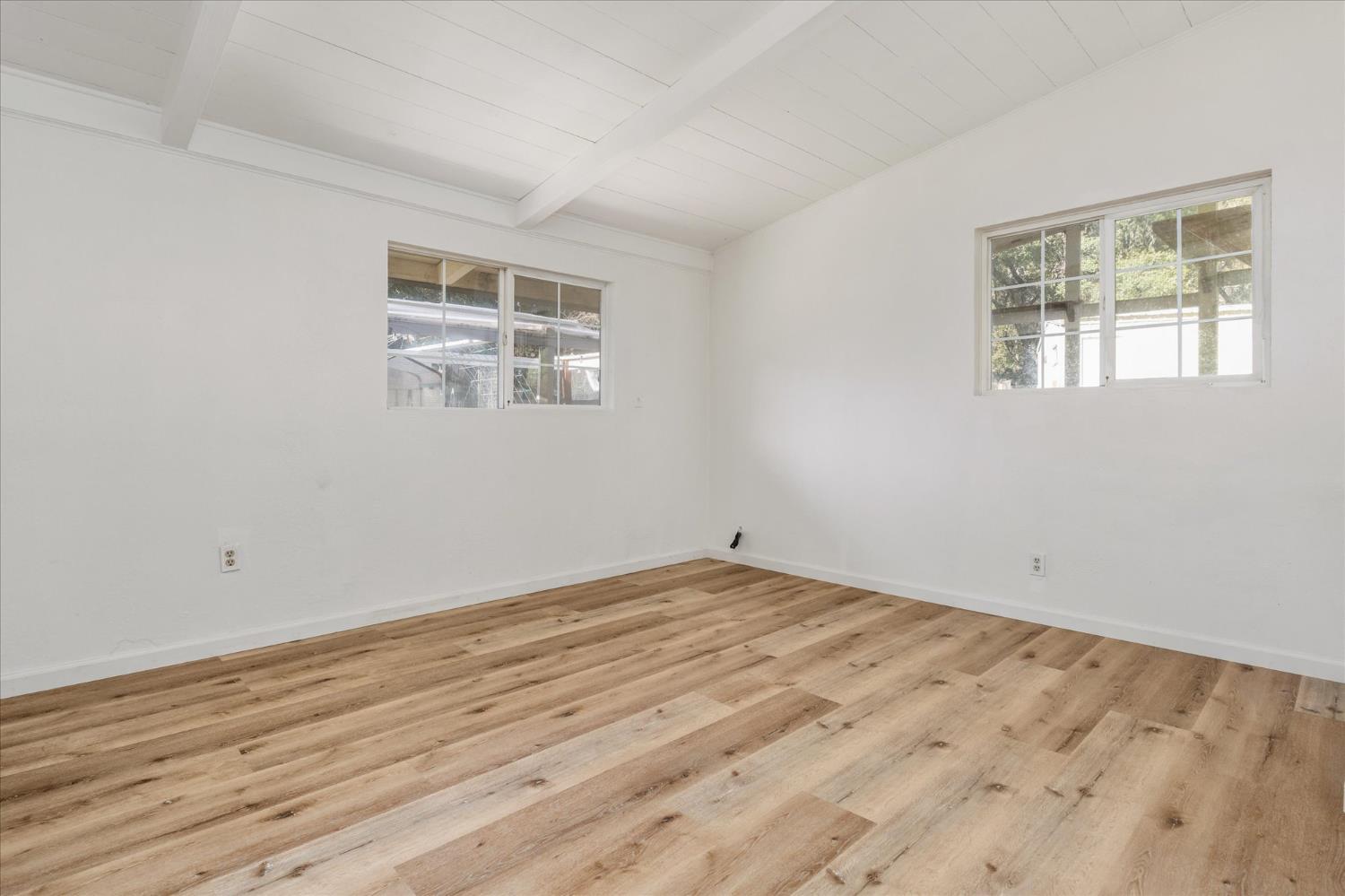8653 Hidden Valley Road Mountain Ranch, CA 95246 - Photo 21 of 41 a view of empty room with wooden floor and fan
