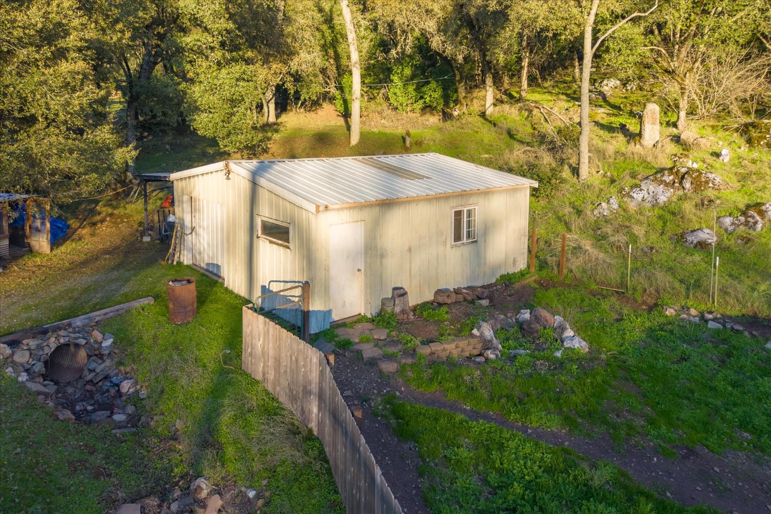 8653 Hidden Valley Road Mountain Ranch, CA 95246 - Photo 30 of 41 a view of a house with a yard and potted plants