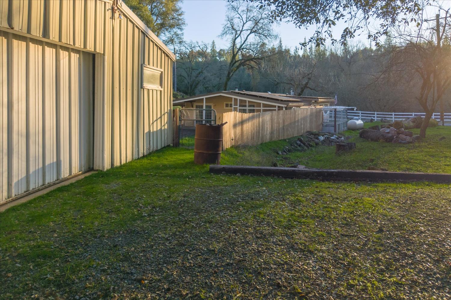 8653 Hidden Valley Road Mountain Ranch, CA 95246 - Photo 32 of 41 a backyard of a house with lots of green space