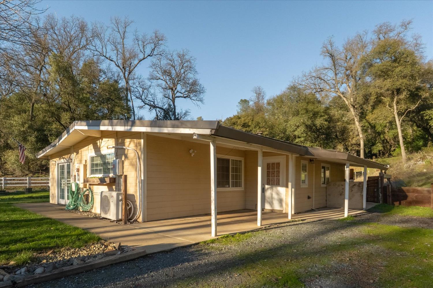 8653 Hidden Valley Road Mountain Ranch, CA 95246 - Photo 4 of 41 a front view of a house with a yard