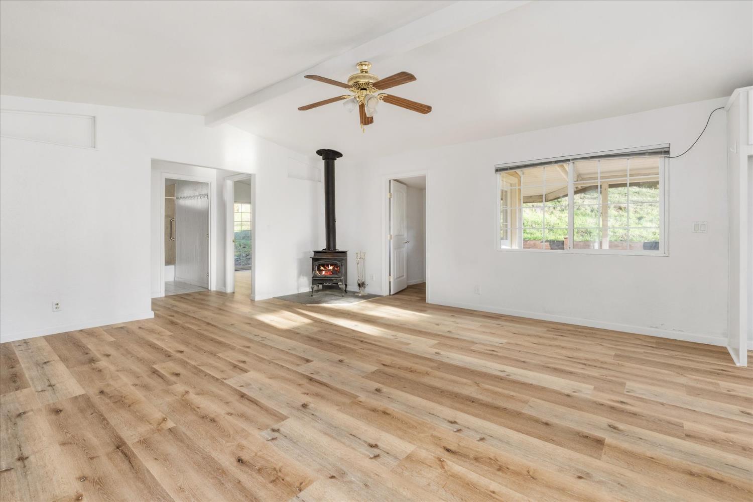 8653 Hidden Valley Road Mountain Ranch, CA 95246 - Photo 6 of 41 a view of empty room with wooden floor and fan