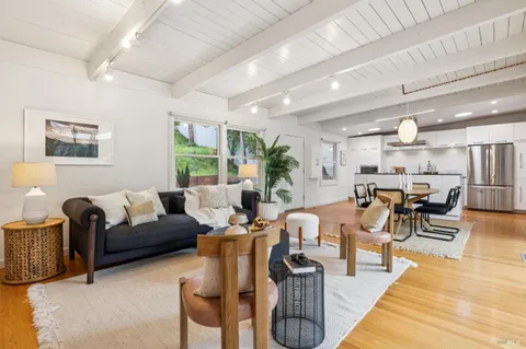 a living room with lots of furniture and a large window