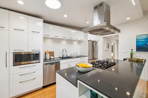 a kitchen with a sink a stove and cabinets