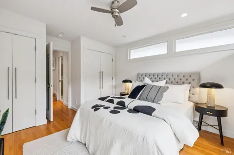 a bedroom with a bed and wooden floor