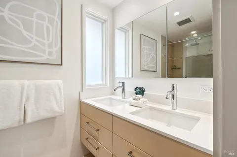 a bathroom with a double vanity sink mirror and