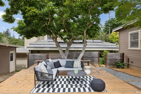 a view of a patio with table and chairs and potted plants
