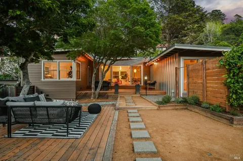 a view of backyard with a patio and outdoor seating