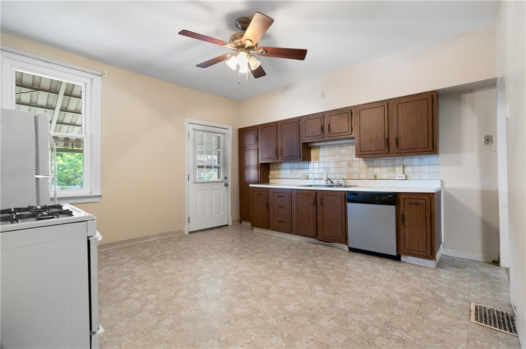 316 Stanton Pittsburgh, PA 15209 - Photo 14 of 32 a kitchen with a cabinets a sink a window and stainless steel appliances