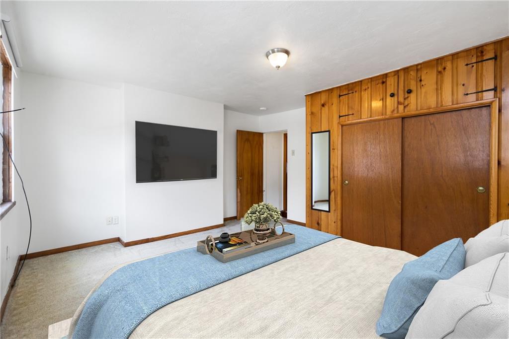 316 Stanton Pittsburgh, PA 15209 - Photo 22 of 32 a bedroom with a bed and a flat screen tv