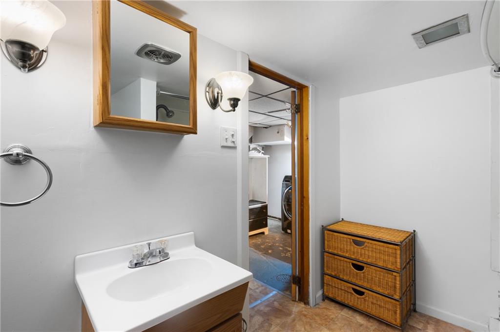 316 Stanton Pittsburgh, PA 15209 - Photo 24 of 32 a bathroom with a sink and a mirror