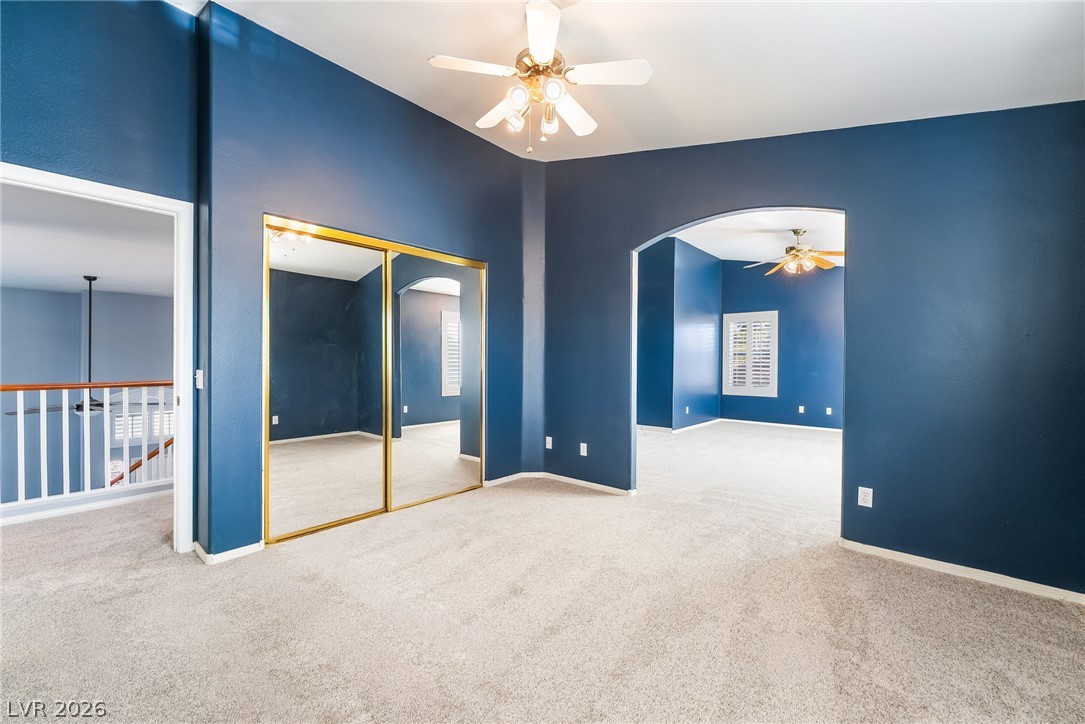 261 Timber Hollow Street Henderson, NV 89012 - Photo 31 of 51 A spacious secondary bedroom with ample natural light offers comfort and versatility.