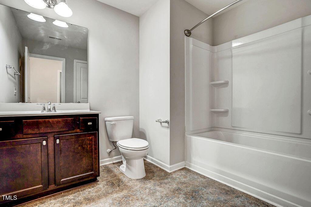 529 Metro Station Apex, NC 27502 - Photo 17 of 28 a bathroom with a sink a toilet and shower