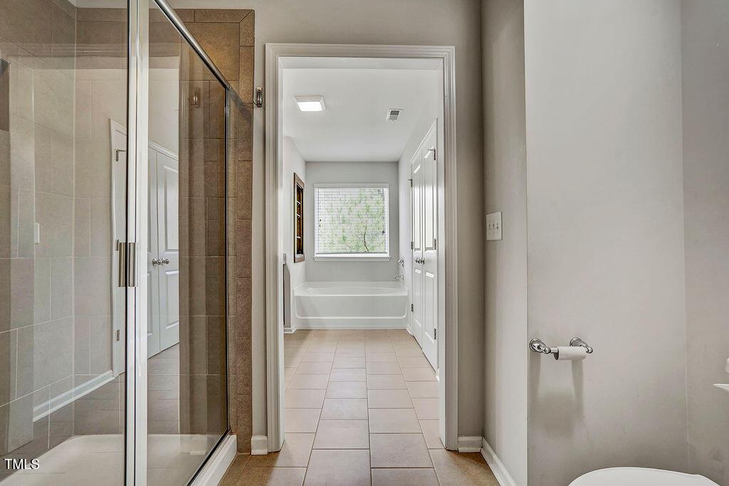 529 Metro Station Apex, NC 27502 - Photo 22 of 28 a bathroom with a glass shower door