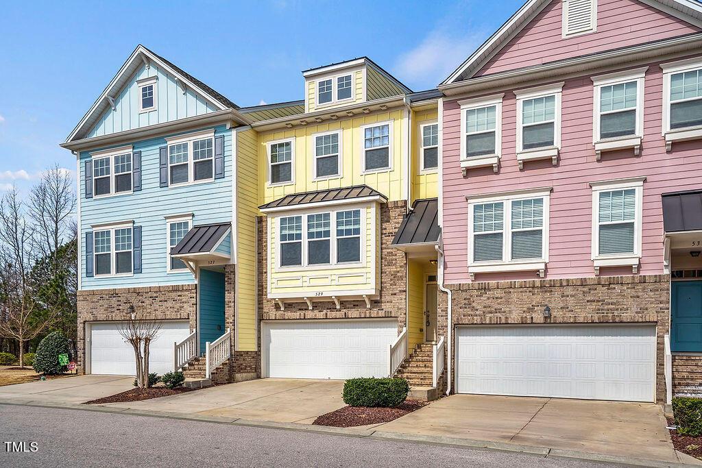 529 Metro Station Apex, NC 27502 - Photo 3 of 28 a front view of a house with a yard and garage