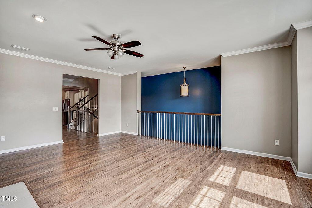529 Metro Station Apex, NC 27502 - Photo 8 of 28 a view of a livingroom with a ceiling fan and wooden floor