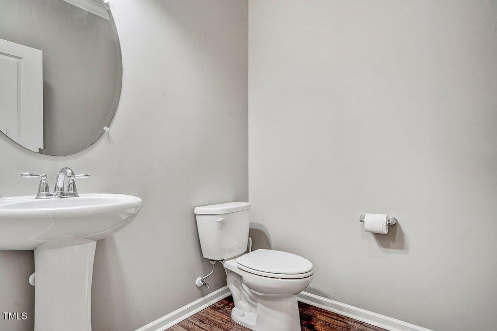 529 Metro Station Apex, NC 27502 - Photo 9 of 28 a bathroom with a toilet a sink and mirror