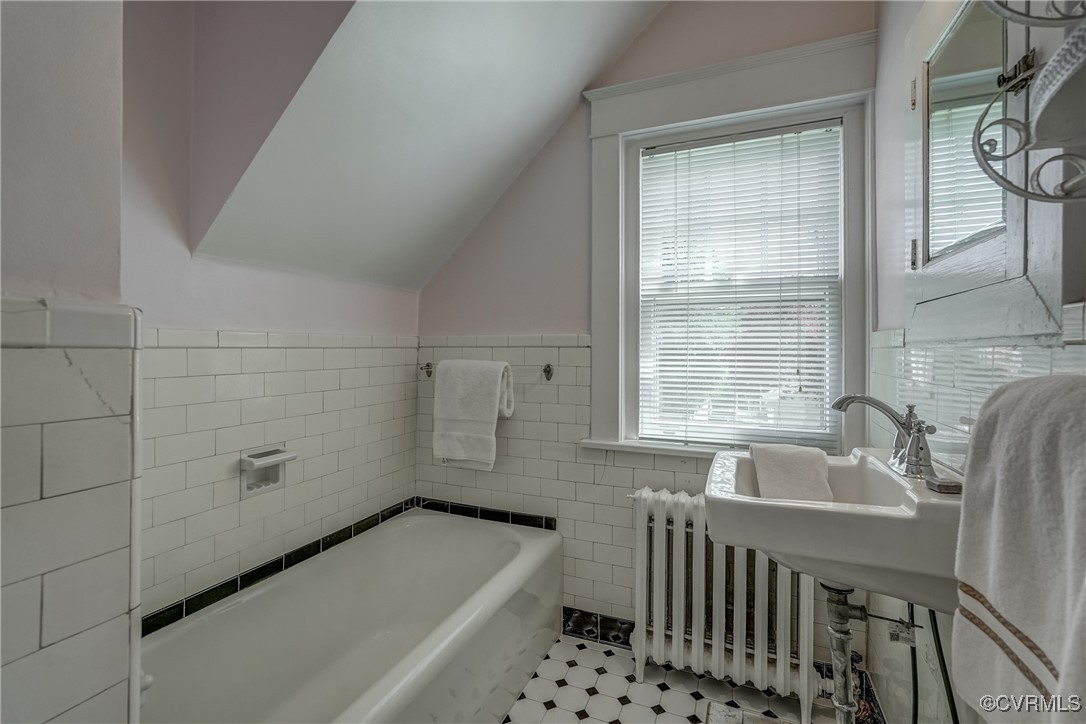 4101 Crestwood Road Richmond, VA 23227 - Photo 28 of 48 a bathroom with a tub a sink and a window